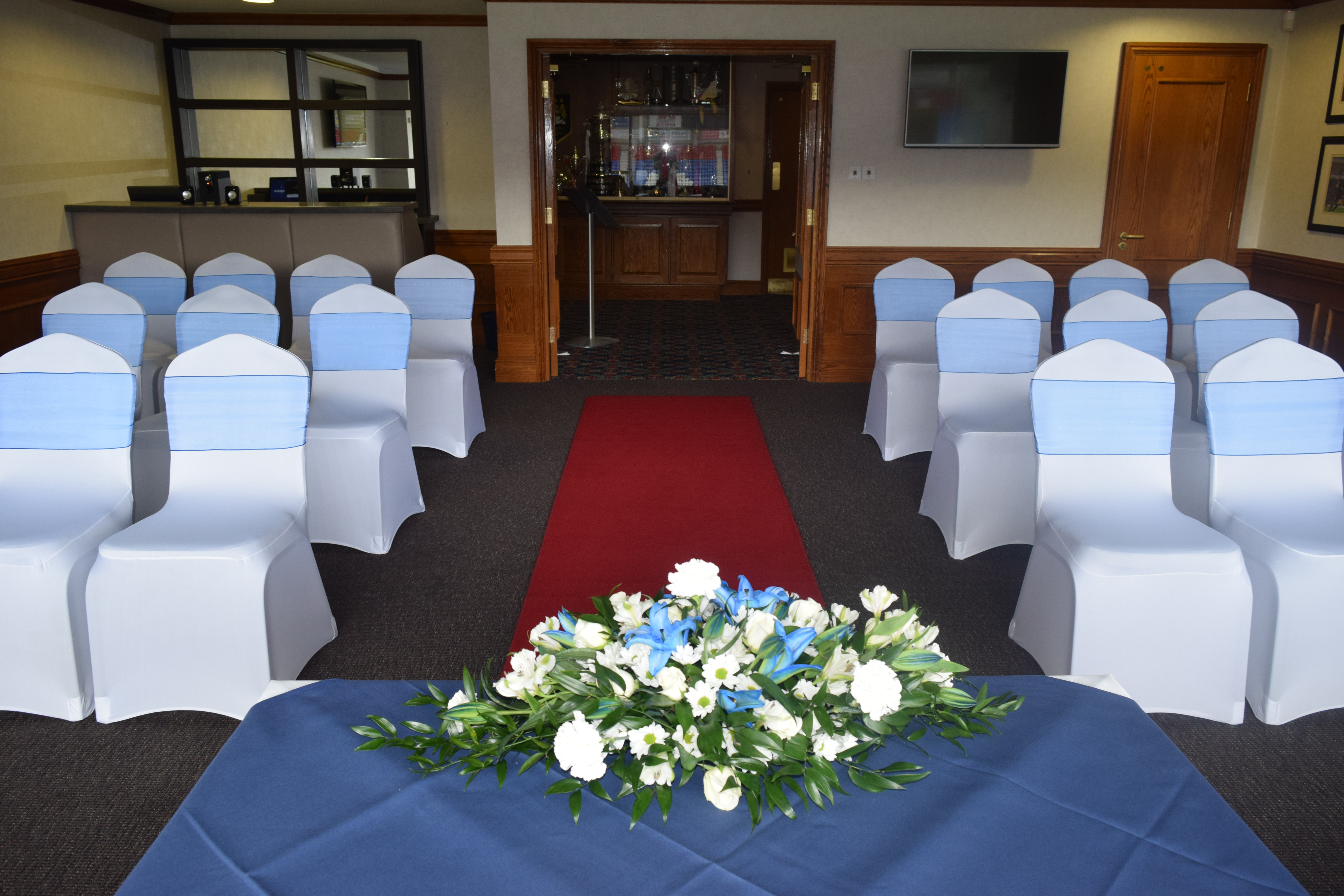 Dave Whelan President's Suite with blue chairs and red carpet, perfect for formal events. - Banner