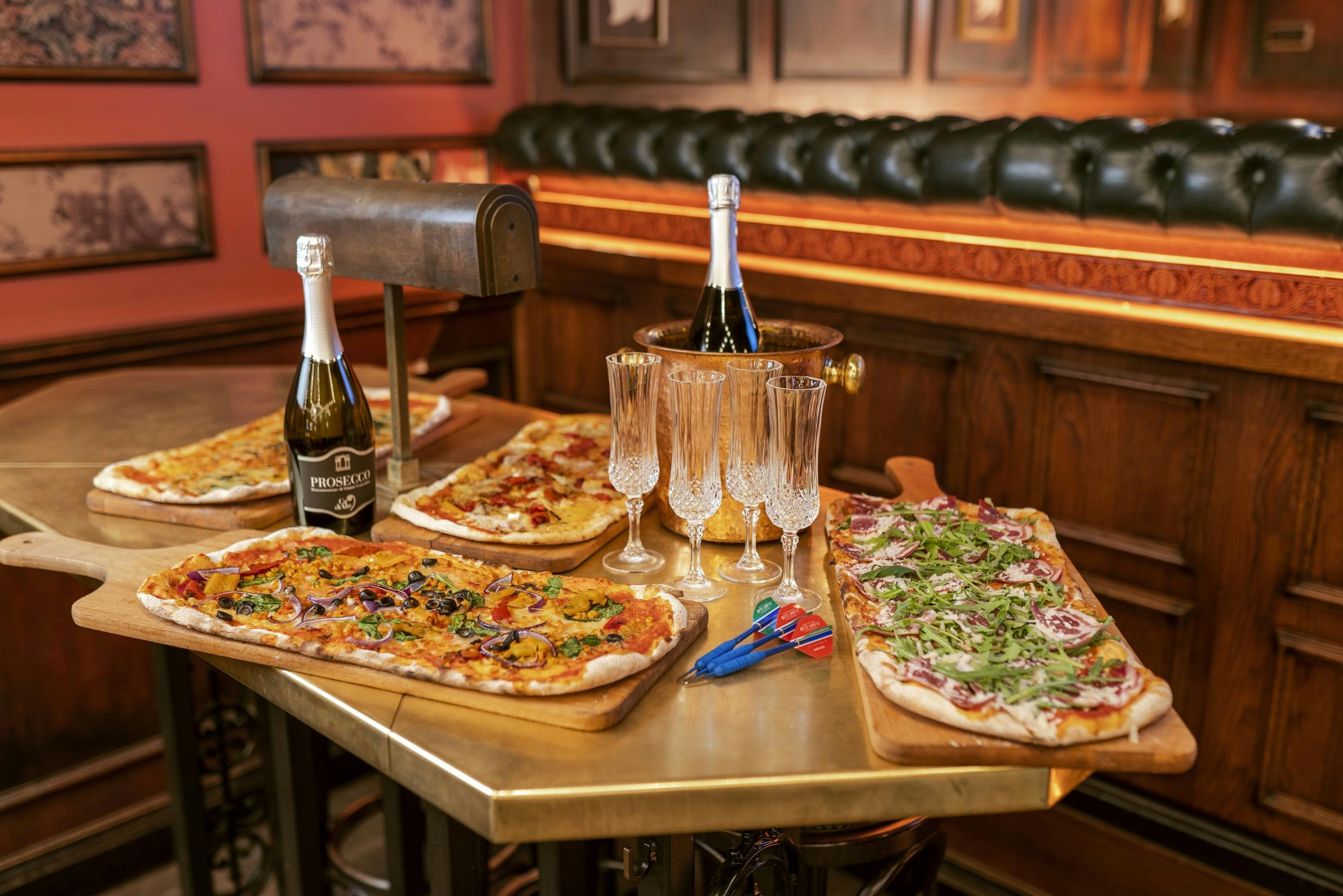 Stylish networking event setup with gourmet flatbreads and sparkling beverages at Flight Club Victoria.