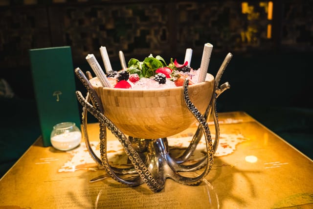 Tropical Escape centerpiece with ice, berries, and mint for upscale events and parties.