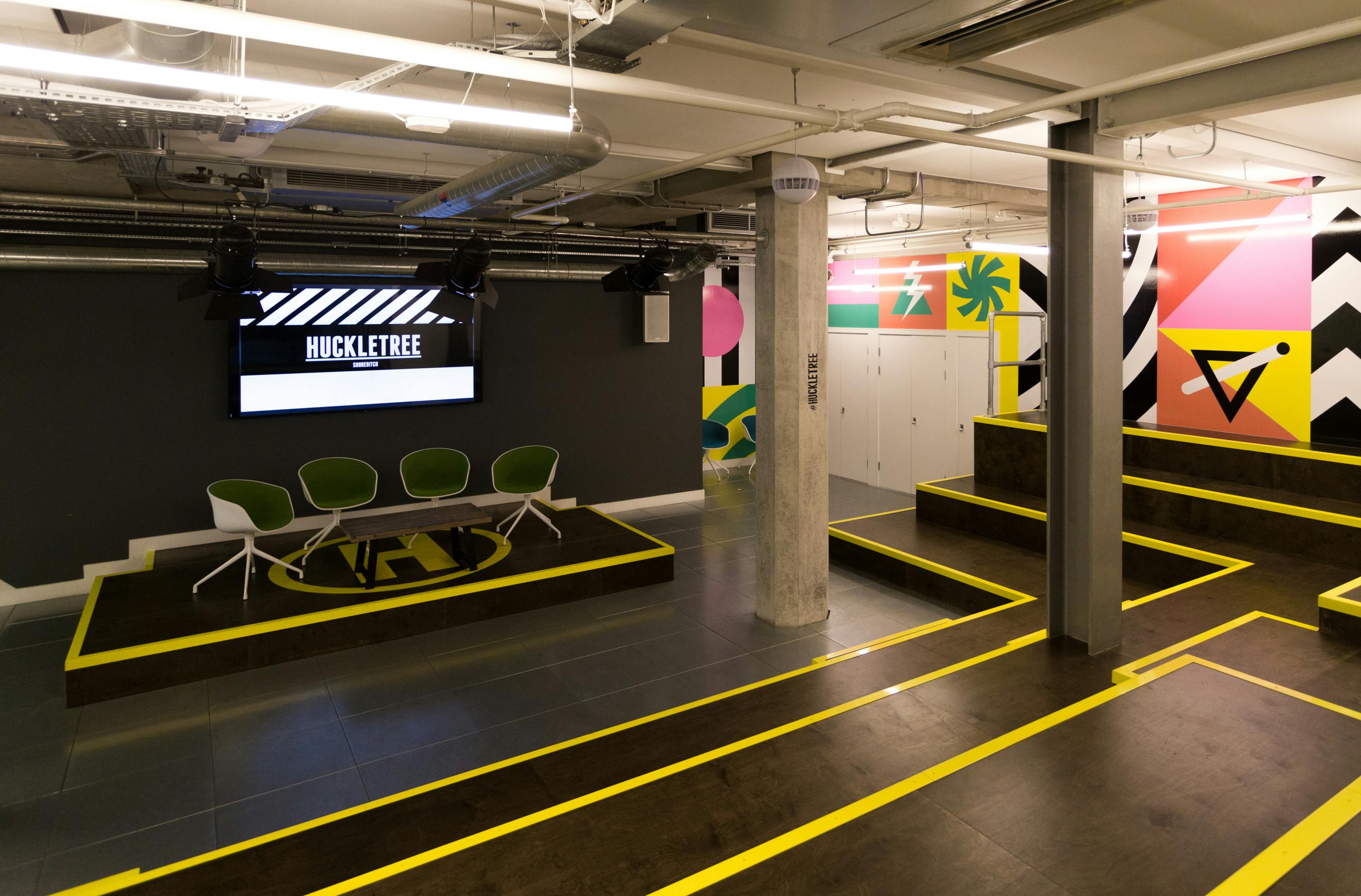 Modern event space in Huckletree Shoreditch with vibrant graphics for workshops and meetings.