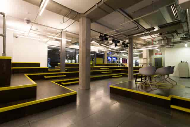 Auditorium event space in Huckletree Shoreditch with tiered seating for workshops and presentations.
