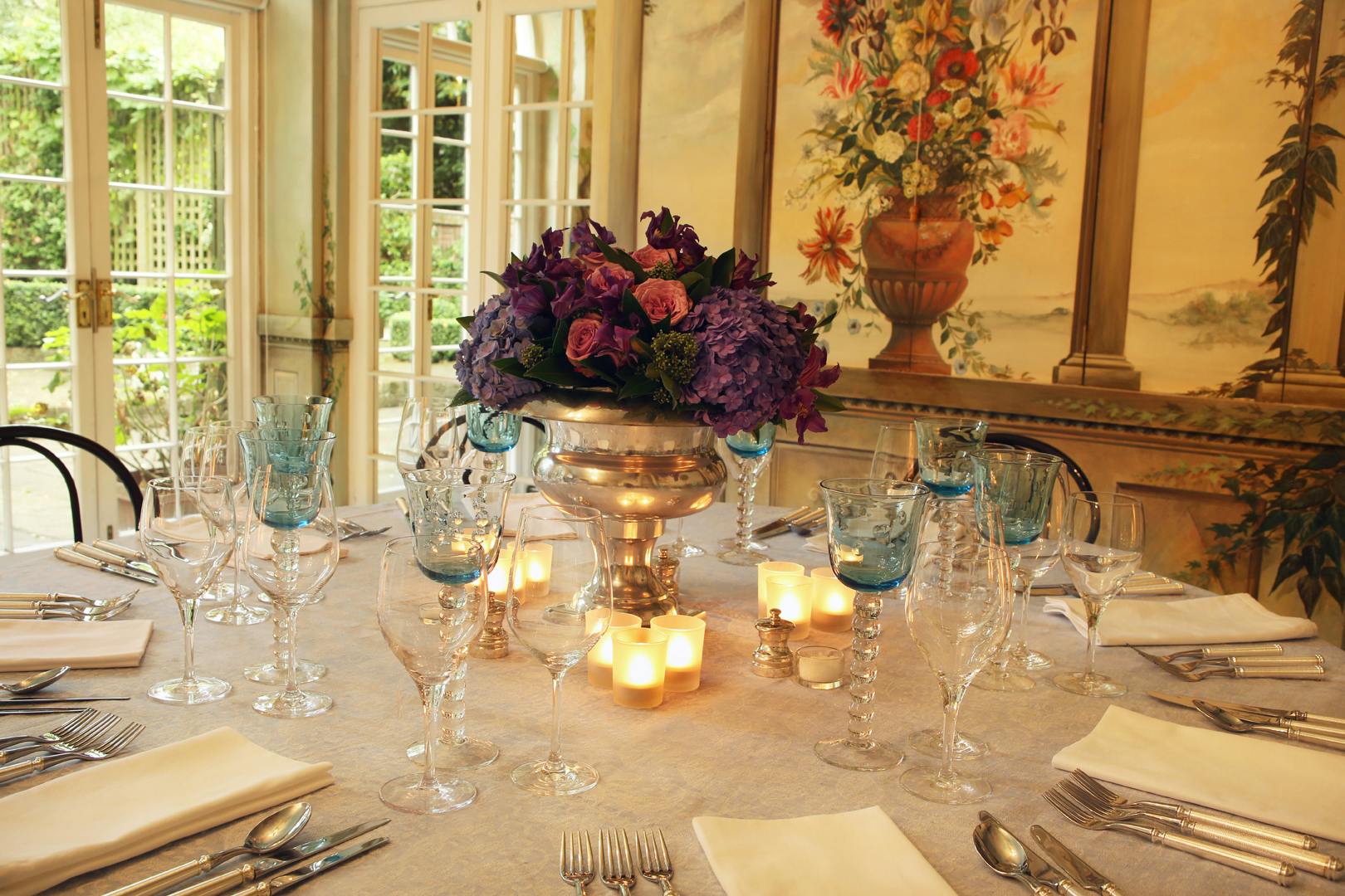 Elegant dining table with floral centerpiece in The Orangery, perfect for weddings and upscale events.