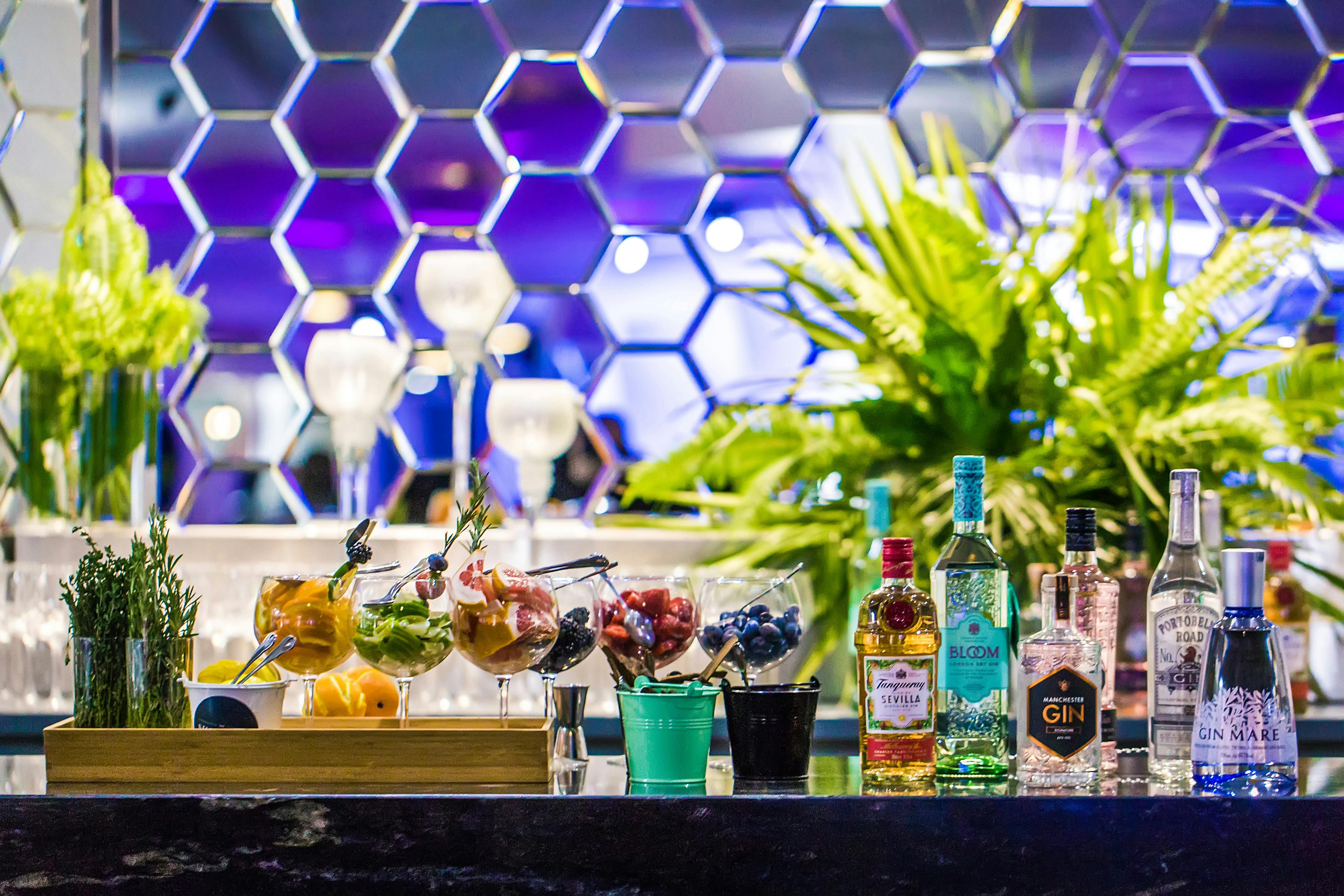 Stylish event space bar with colorful cocktails, ideal for networking and celebrations.