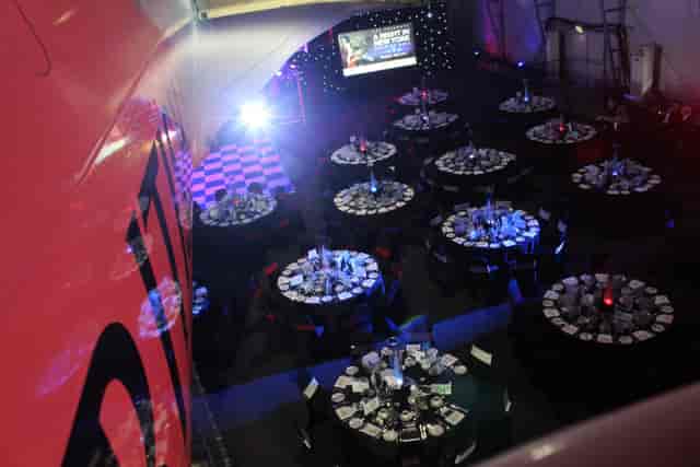 Christmas party setup with elegant tables and stage at Concorde Conference Centre.