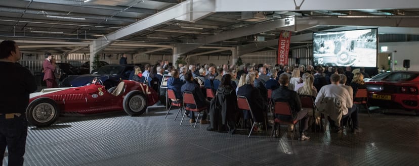 Spacious garage event with vintage car, perfect for automotive and luxury brand gatherings.
