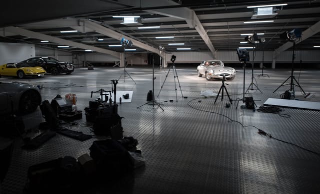 Well-lit automotive studio with sleek cars for product launch or promotional event.