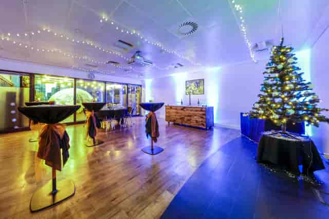 Christmas Room at Docklands Sailing Centre, holiday networking space with high-top cocktail tables.