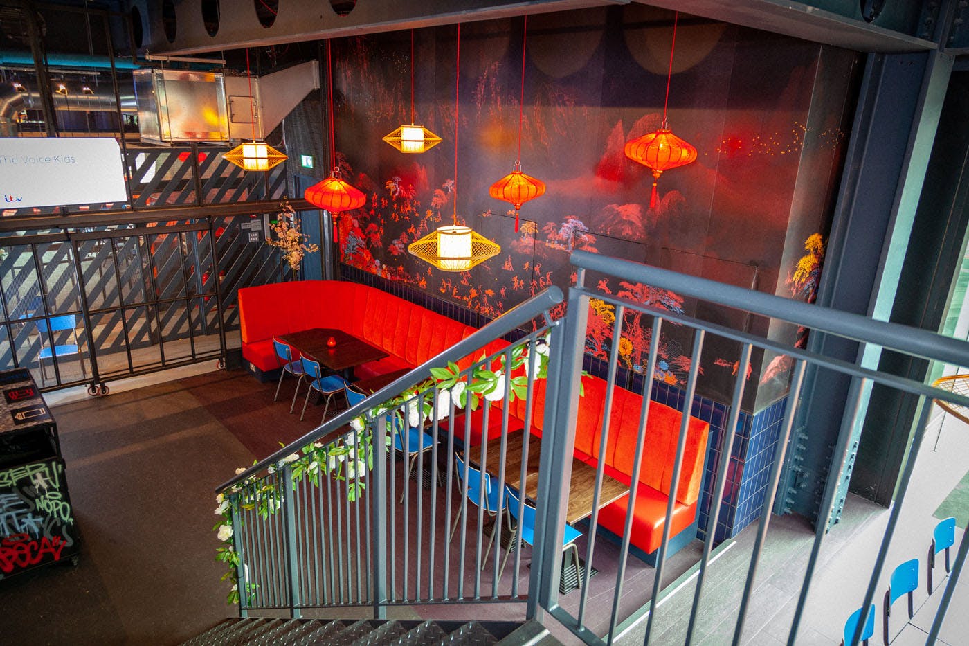 Vibrant Chinatown meeting space with red seating, ideal for informal gatherings and brainstorming.