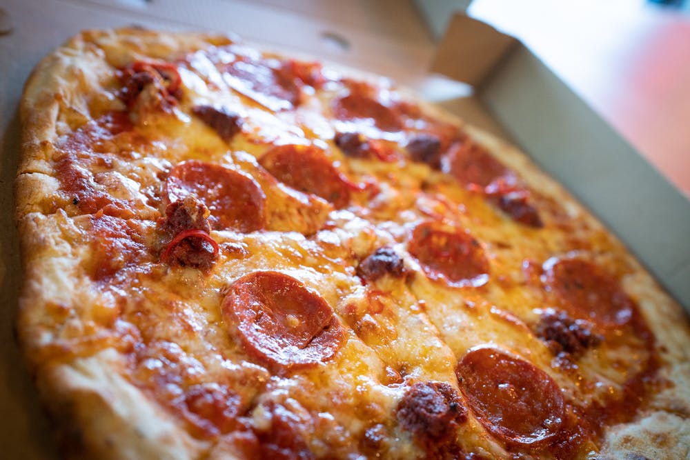 Pepperoni pizza in Secret Room, HUCKSTER London for casual meetings and networking events.