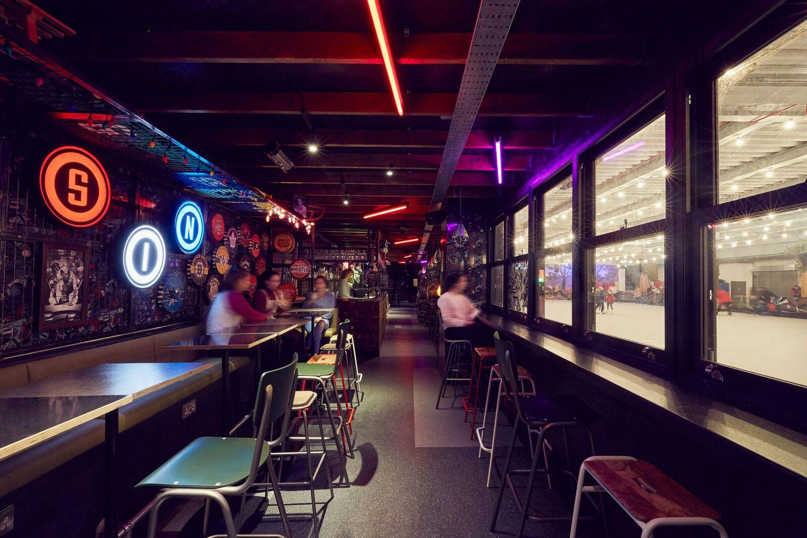 Vibrant event space with neon lighting at The Sin Bin, ideal for networking and gatherings.