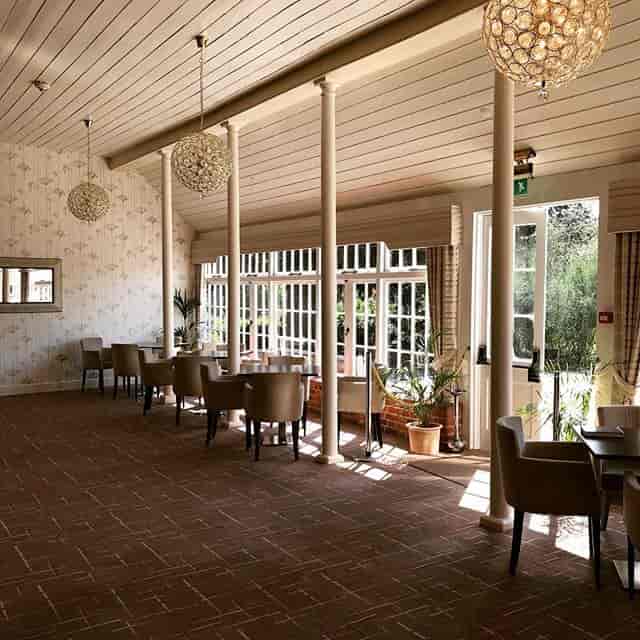 Bright event space at The Coach House with large windows, ideal for workshops and gatherings.