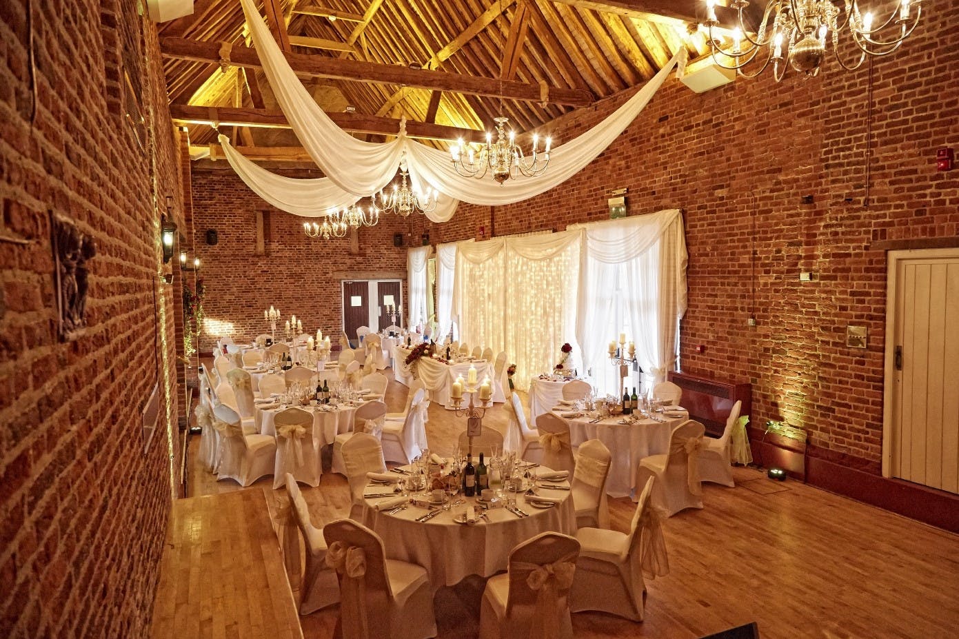 Elegant event space at The Coach House with round tables, ideal for weddings and gatherings.