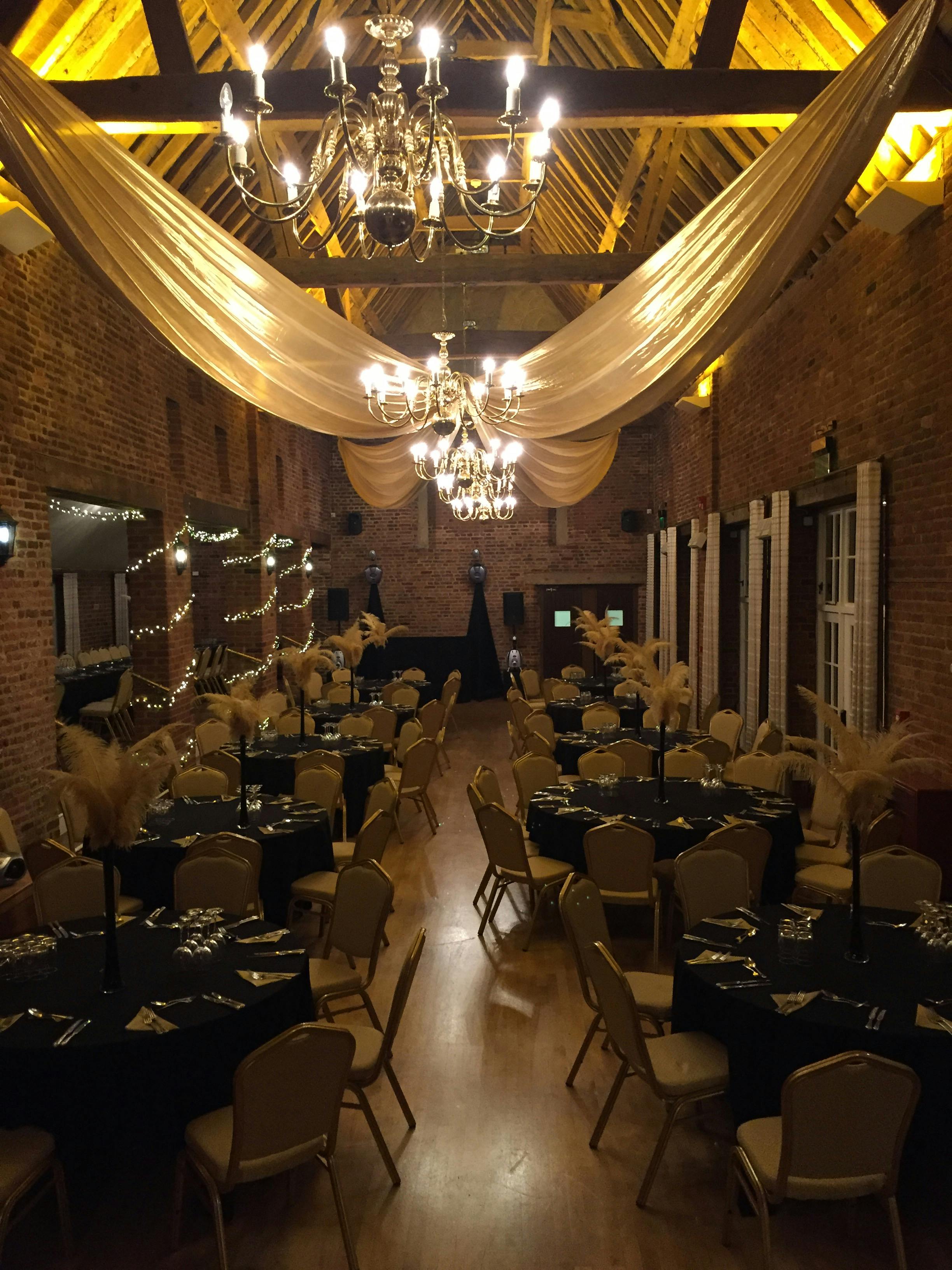 Elegant round tables with black and gold decor at Forty Hall Christmas event.