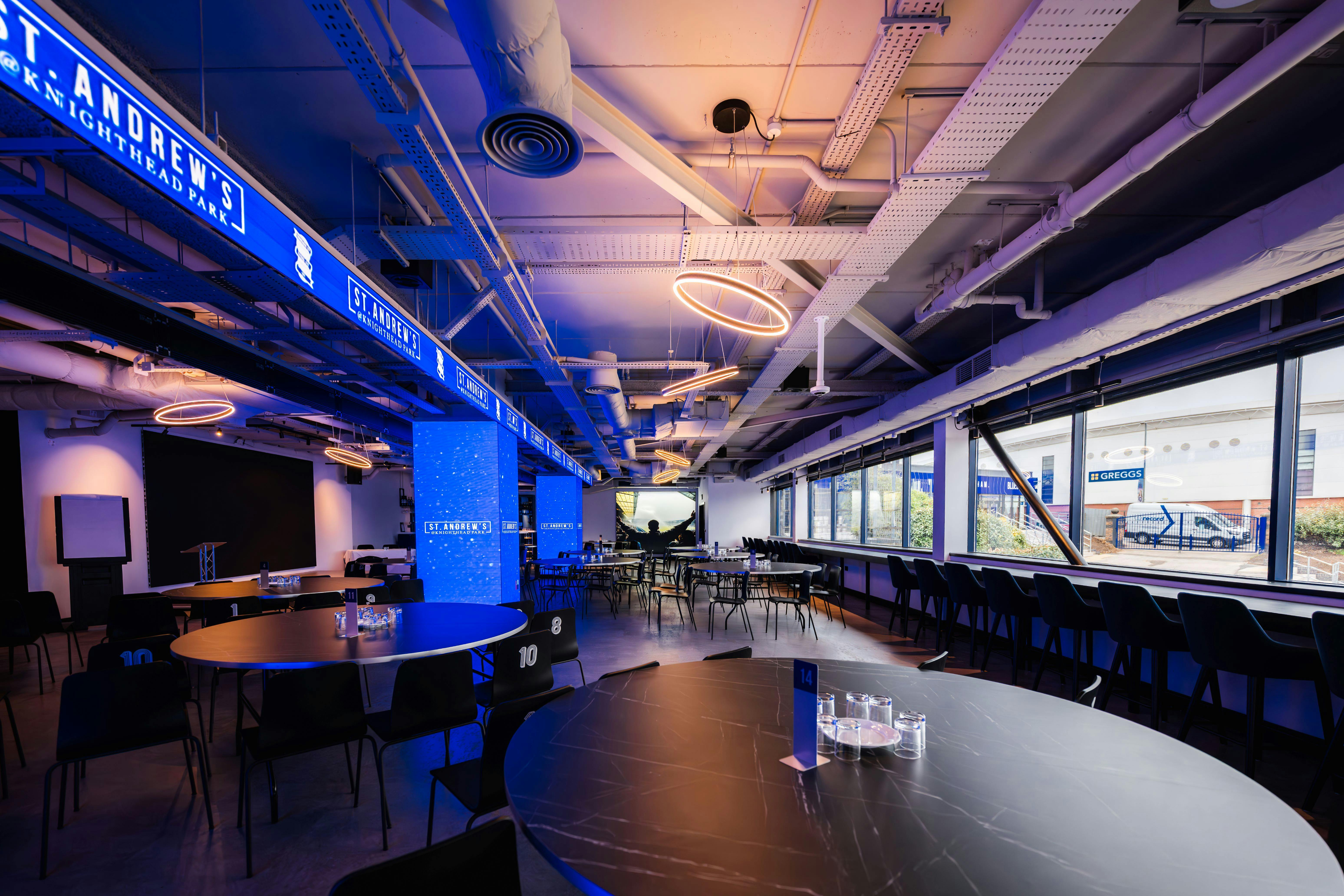 Modern Sponsors Lounge at Birmingham City FC with blue lighting for events and meetings.