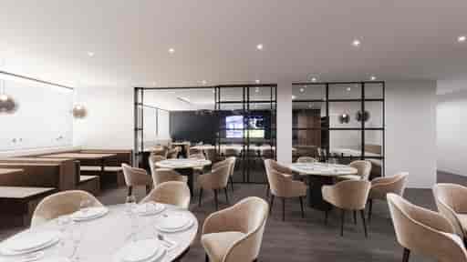 Modern event space at Birmingham City FC with elegant round tables for corporate meetings.