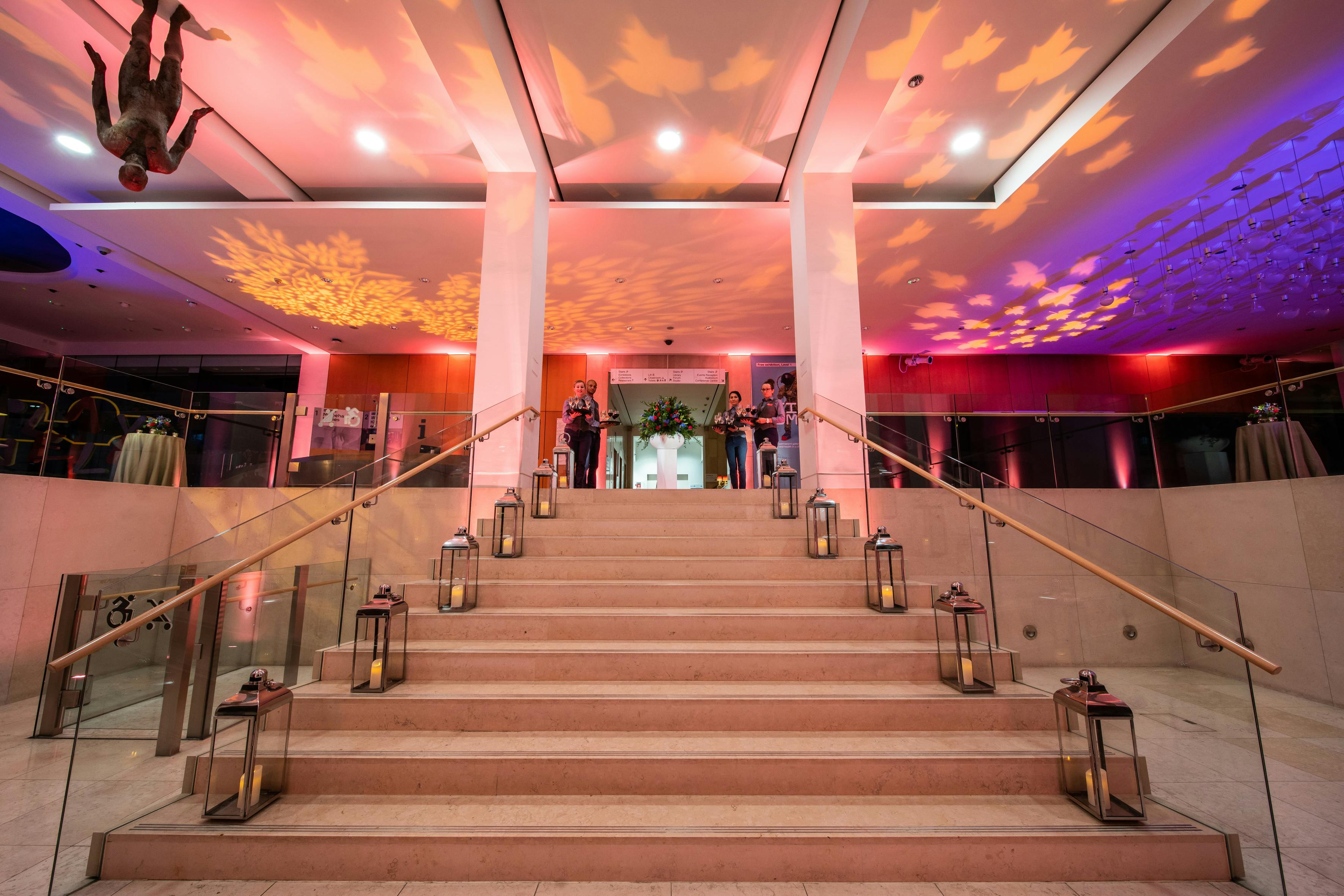 Elegant Atrium staircase with warm lighting, perfect for weddings and corporate events.