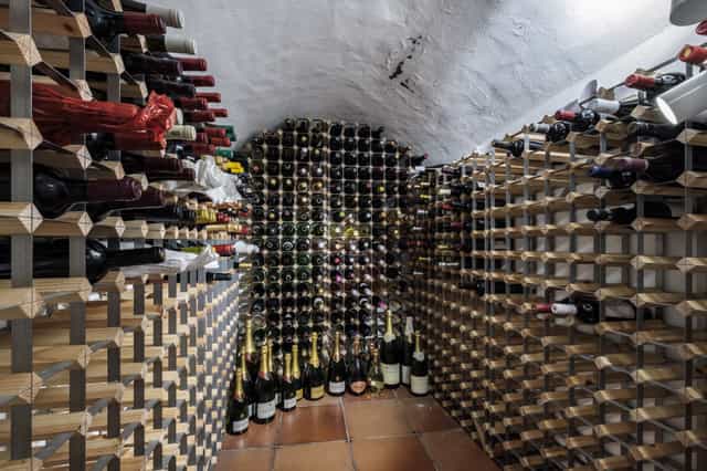 Elegant wine cellar venue with organized racks for intimate tastings and private dinners.