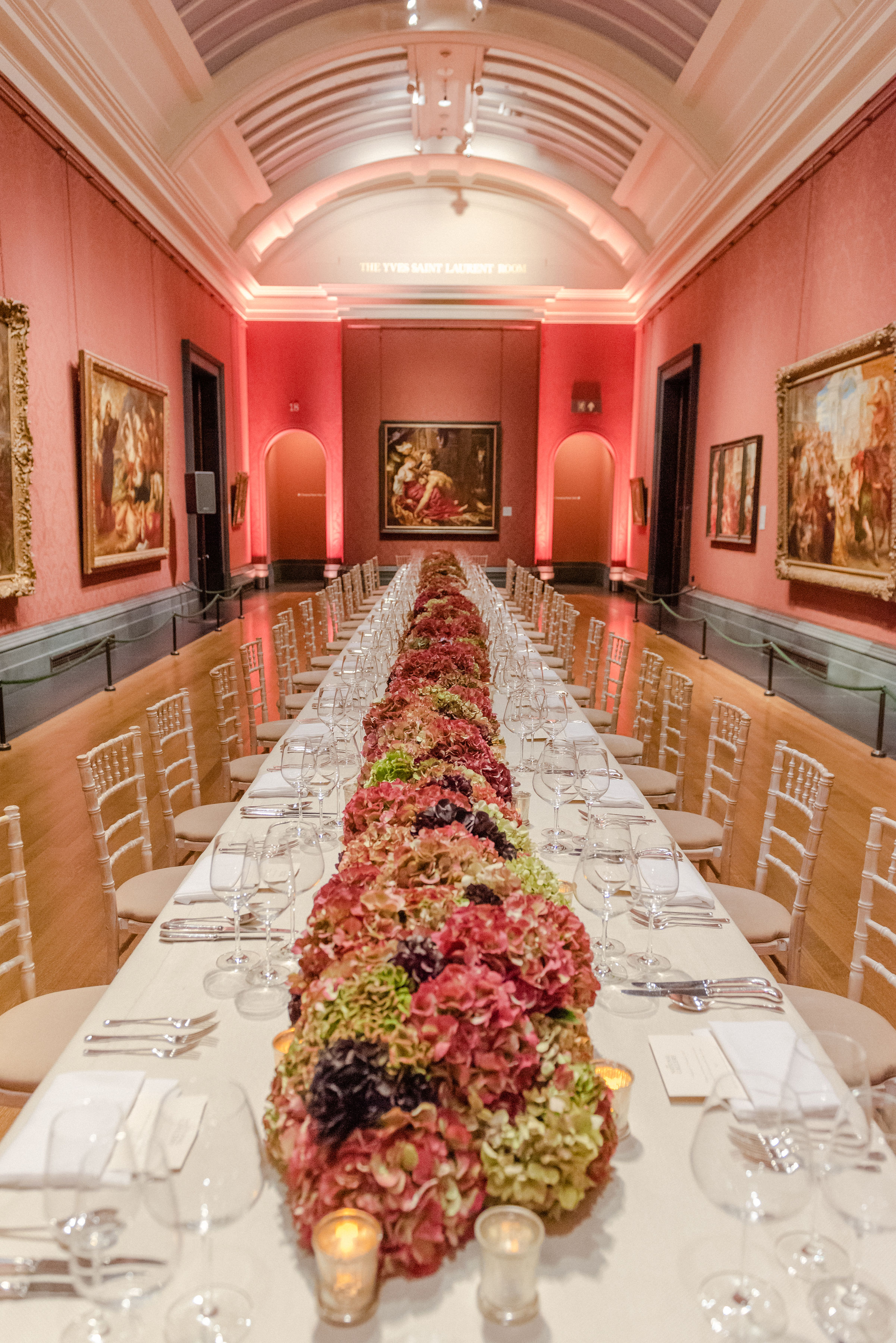 Yves Saint Laurent Room dining table with floral centerpieces for upscale events.