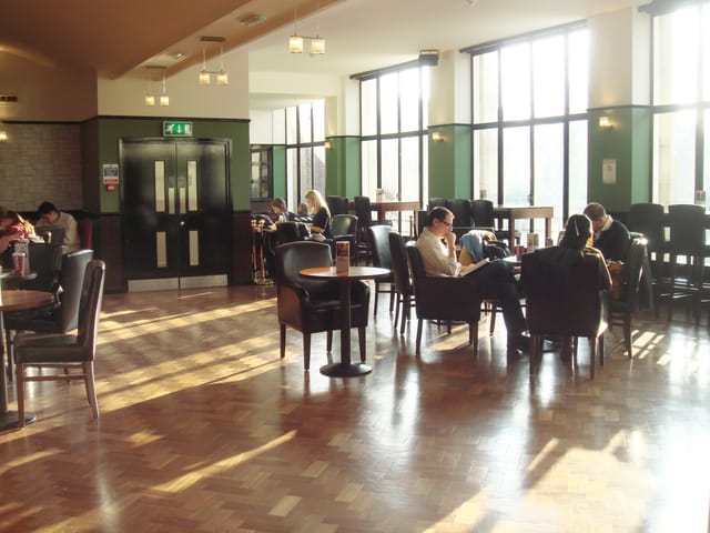 Spacious Main Bar Cafe with natural light, perfect for networking events and meetings.