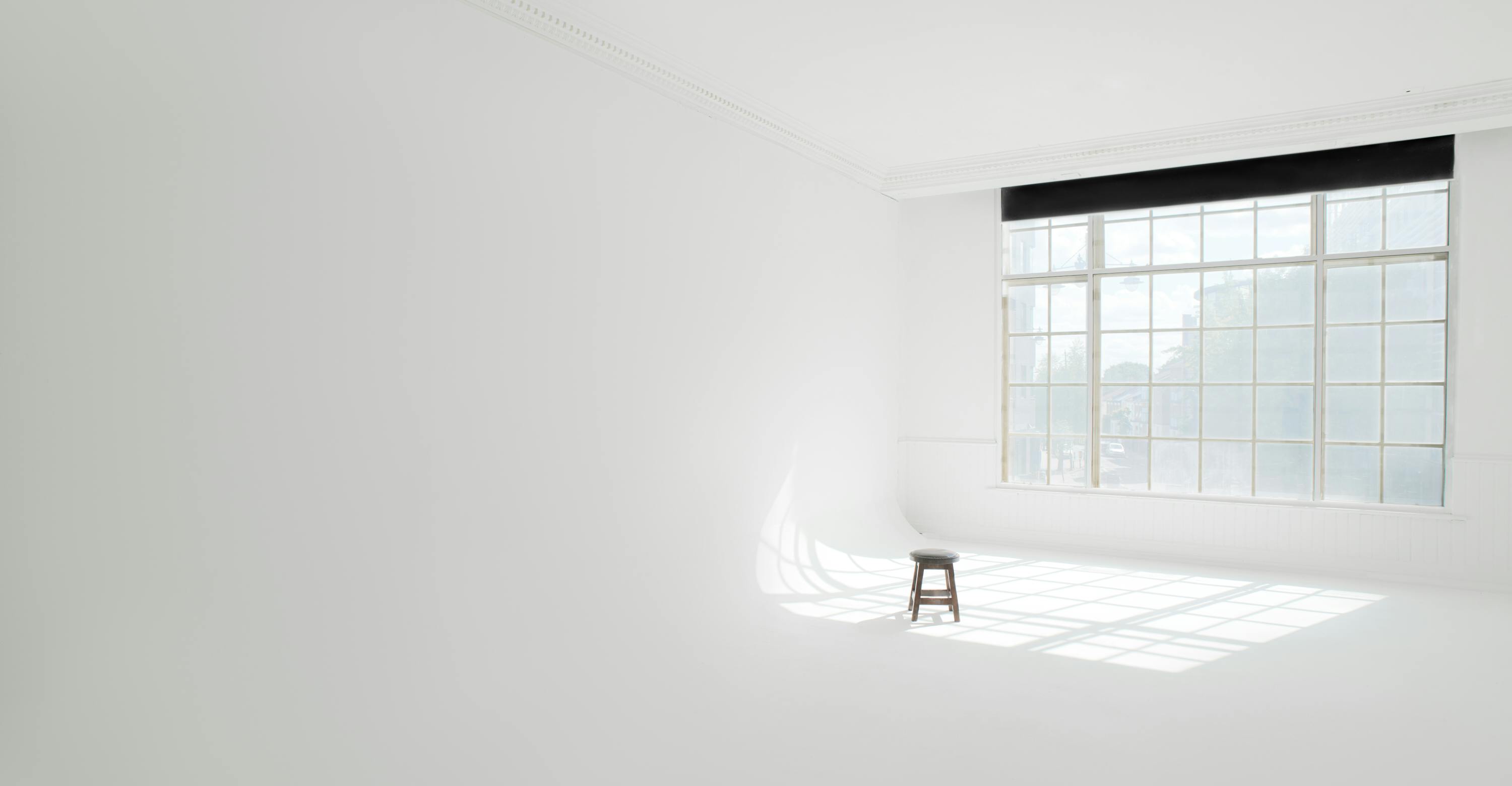 Minimalist event space with natural light for creative workshops in Wimbledon Studio.