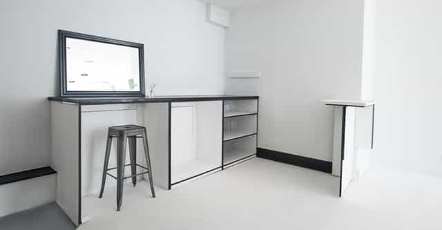 Minimalist event space with sleek bar, ideal for networking and cocktail receptions.