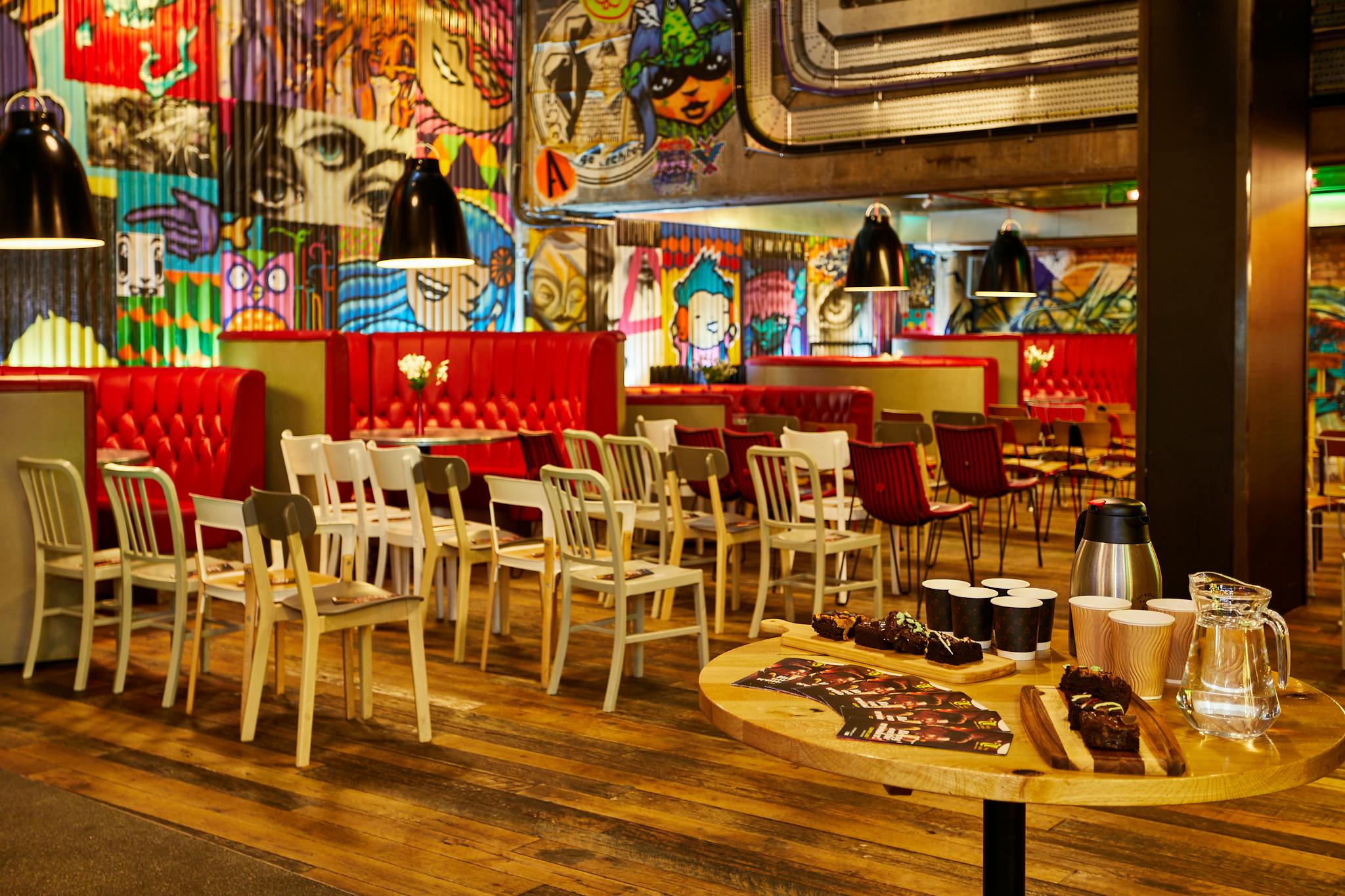 Vibrant urban courtyard with graffiti art, perfect for networking events and gatherings.