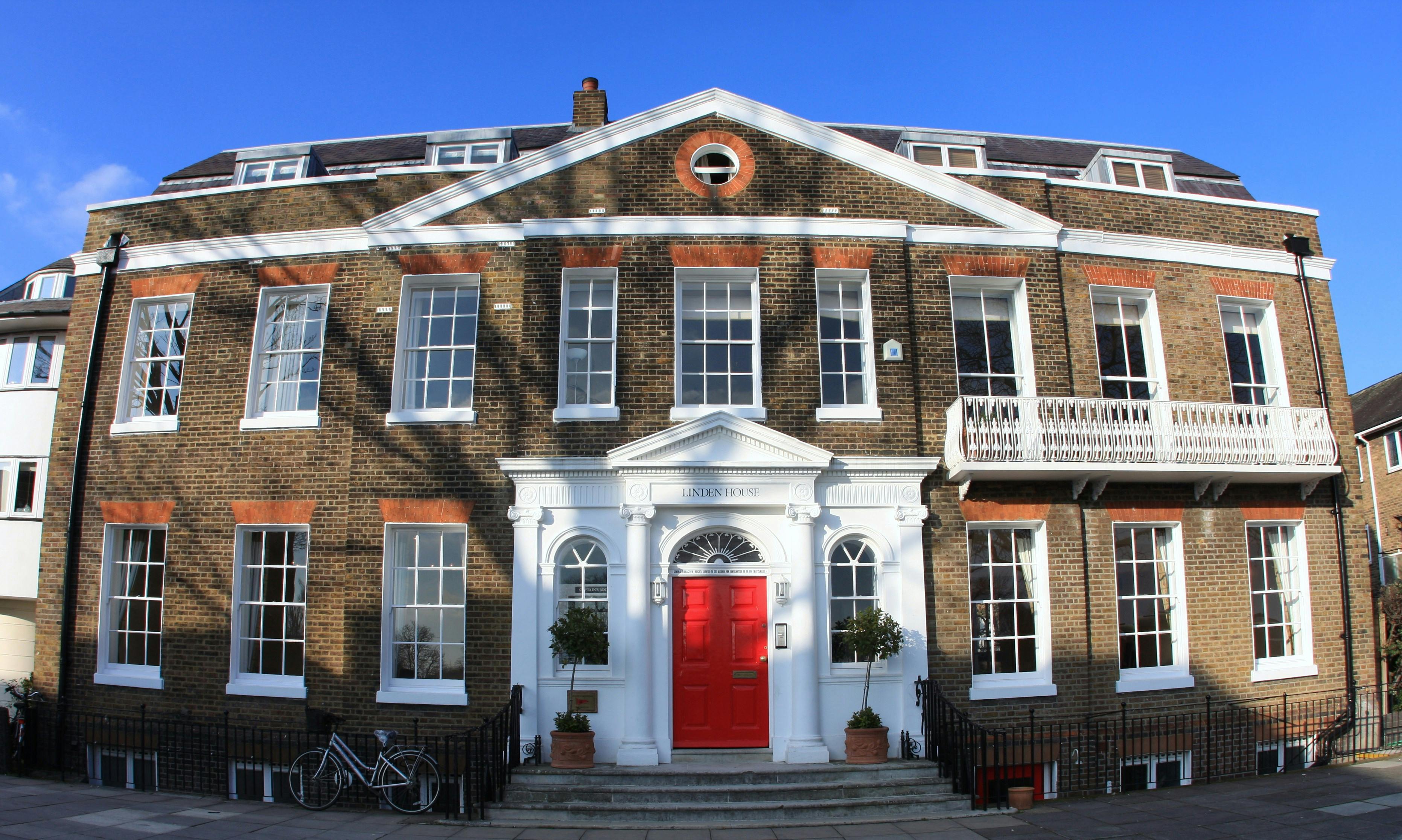 Historic Linden House ballroom with red door, perfect for events and meetings.