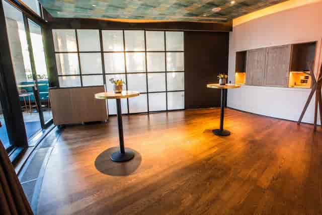 Private dining room with polished wooden floors, ideal for networking events and receptions.