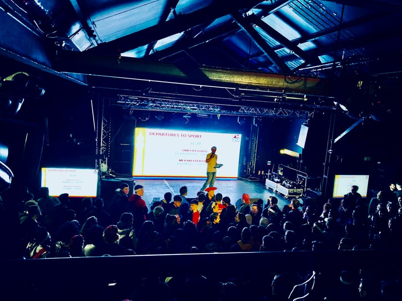 "Main room at XOYO Birmingham with speaker, vibrant lighting, and engaged audience."