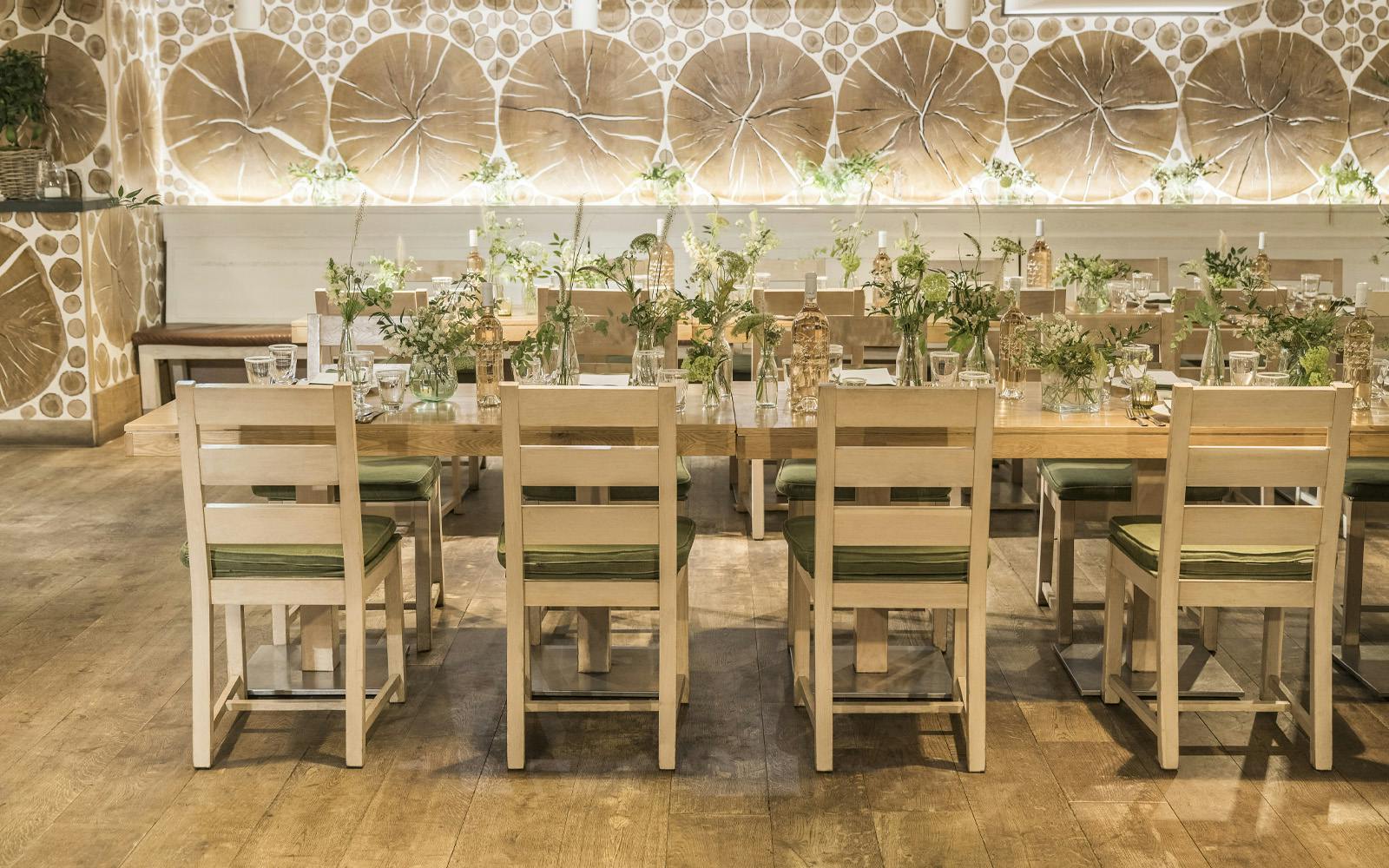 Event space at Daylesford Organic with wooden table, floral decor for gatherings.