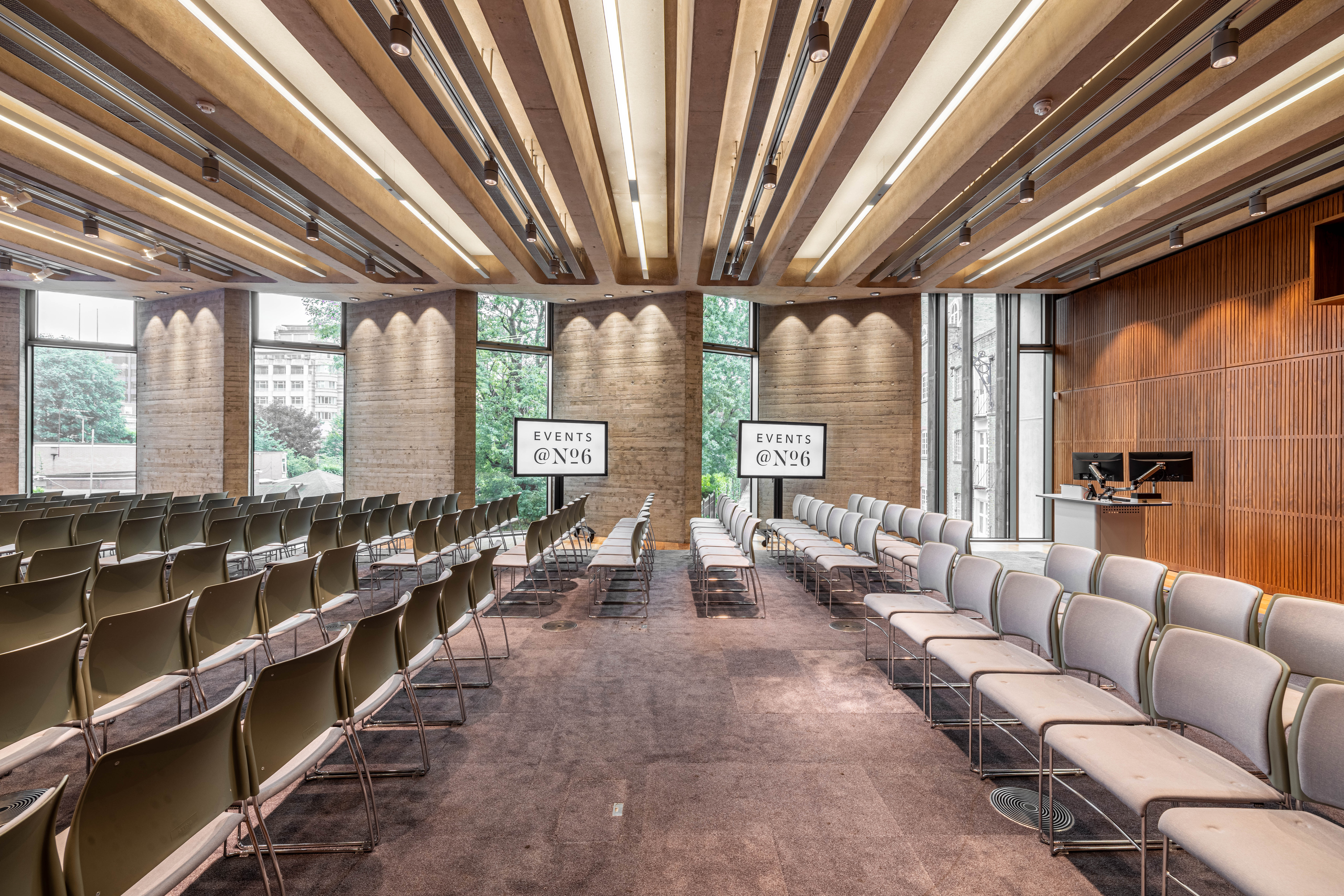 Modern event space with seating and screens for corporate meetings at Events @ No 6. - Banner