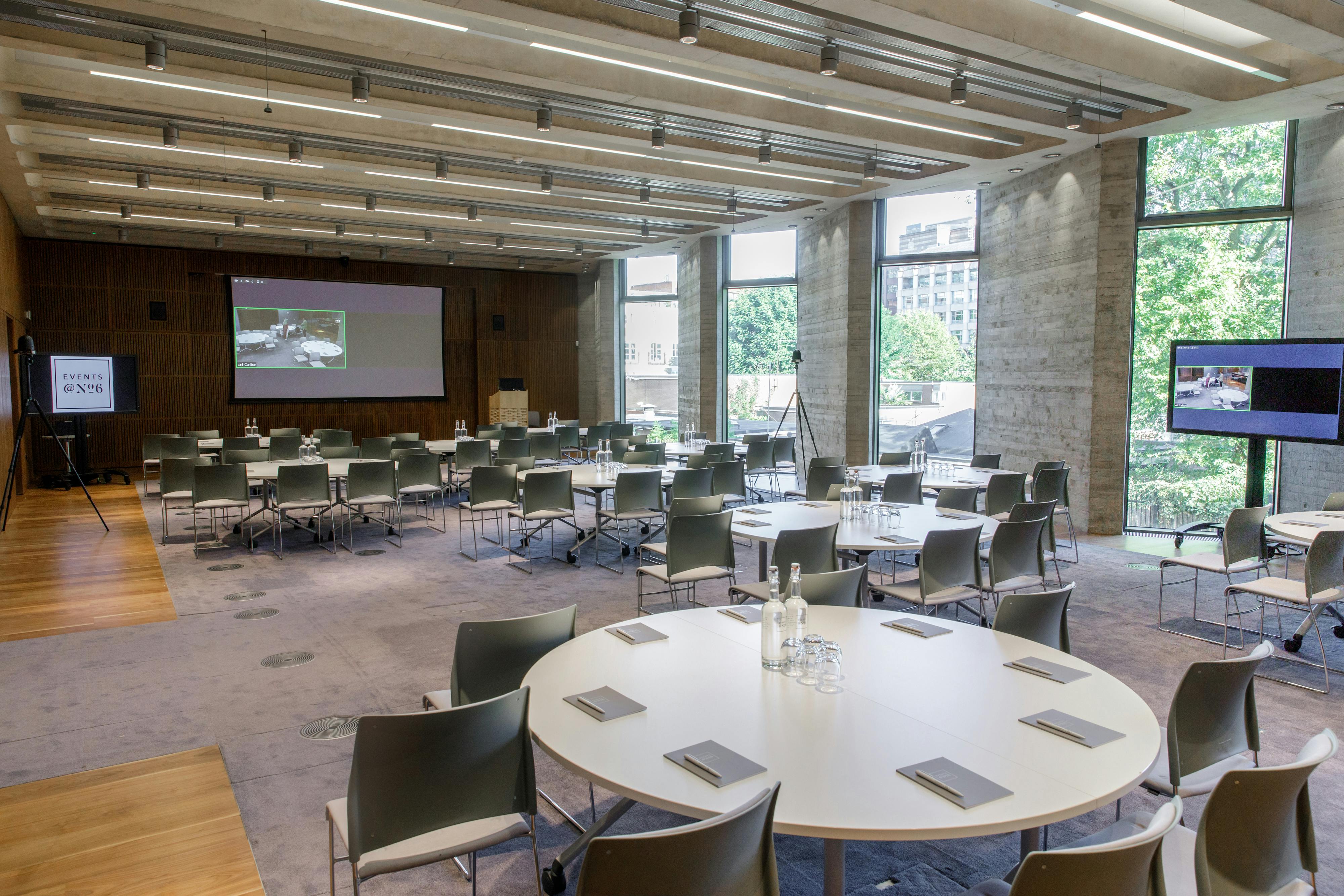 Versatile event space with round tables, ideal for meetings and conferences.