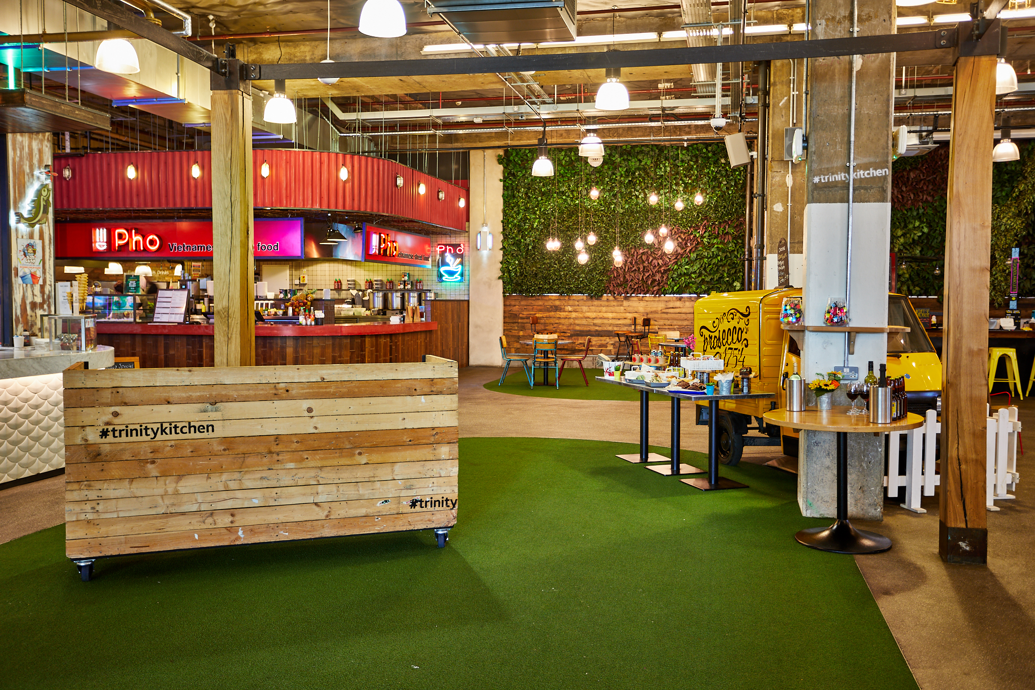 Urban Park food hall with greenery, ideal for casual gatherings and networking events. - Banner