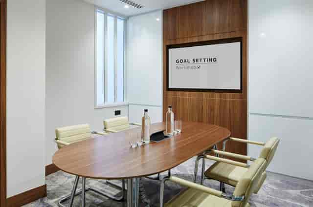 Modern meeting room at London Heathrow Marriott with sleek wooden table for workshops.