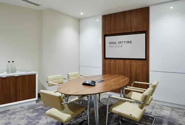 Modern meeting room at London Heathrow Marriott with round table for strategic planning.