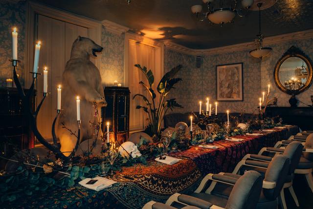 Elegant event space with taxidermy polar bear, perfect for exclusive dinners and themed events.