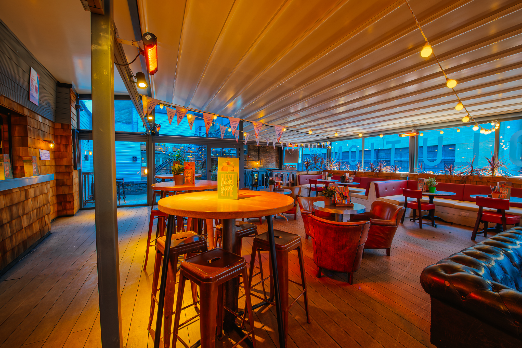 Rooftop Bar in Revolution Cambridge, vibrant event space with stylish seating for gatherings. - Banner