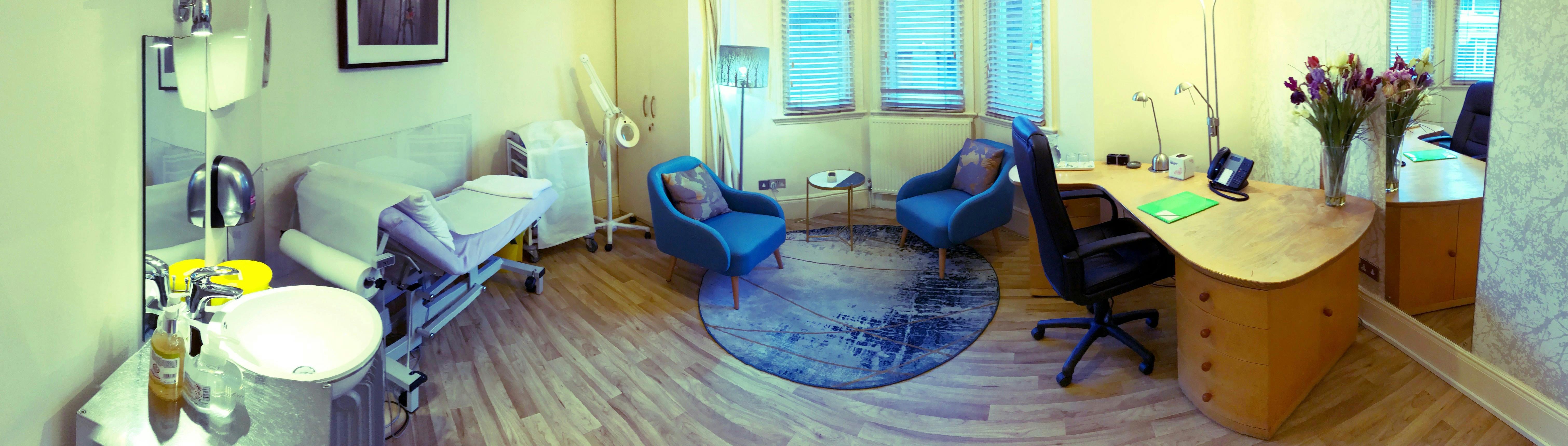 Cozy consulting room with blue chairs for health consultations and wellness events.