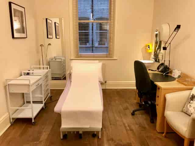 Well-organized consulting room with treatment table for wellness events and corporate retreats.