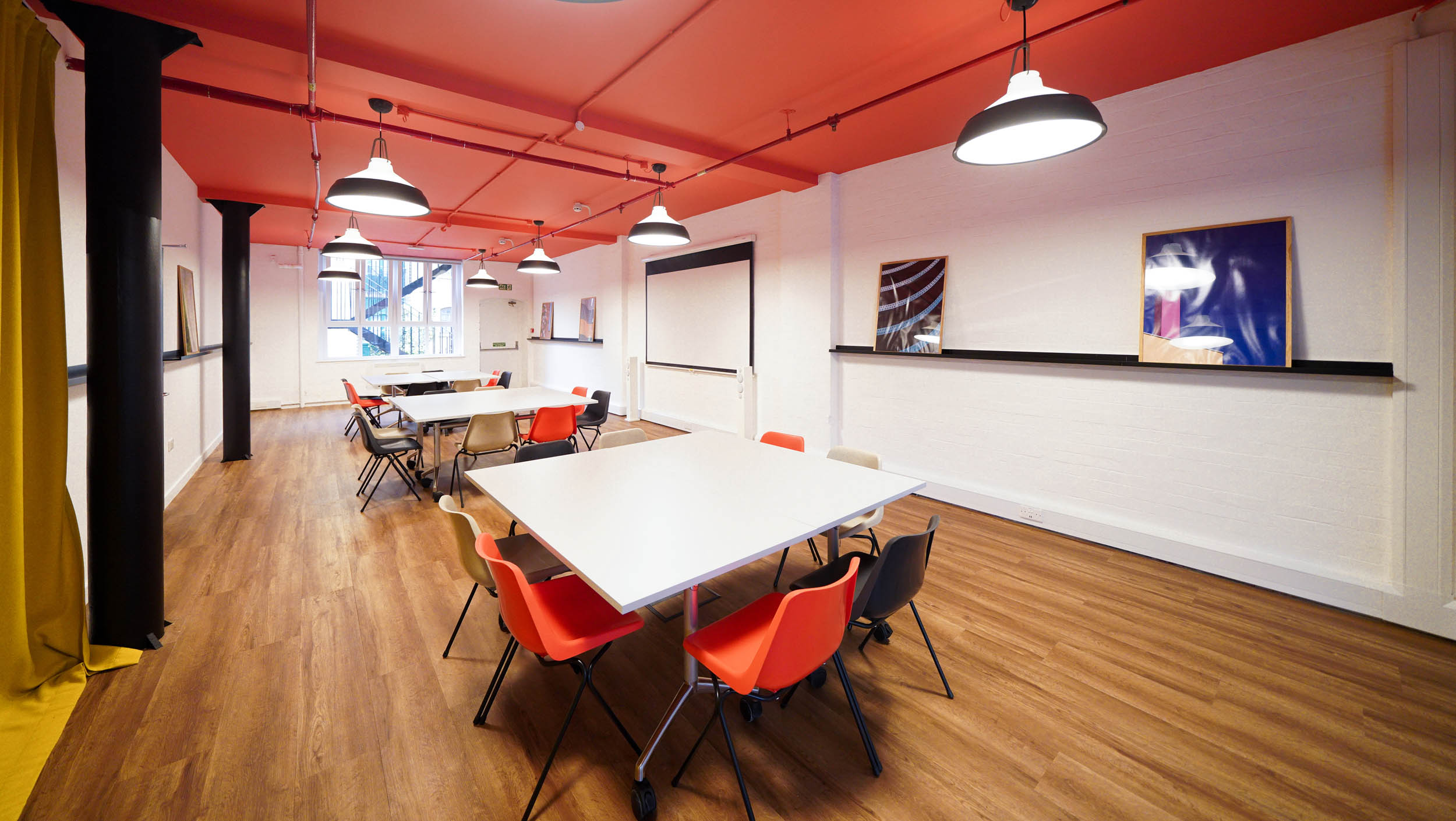 Modern meeting space at The Hive, London Bridge with vibrant orange ceiling for workshops.