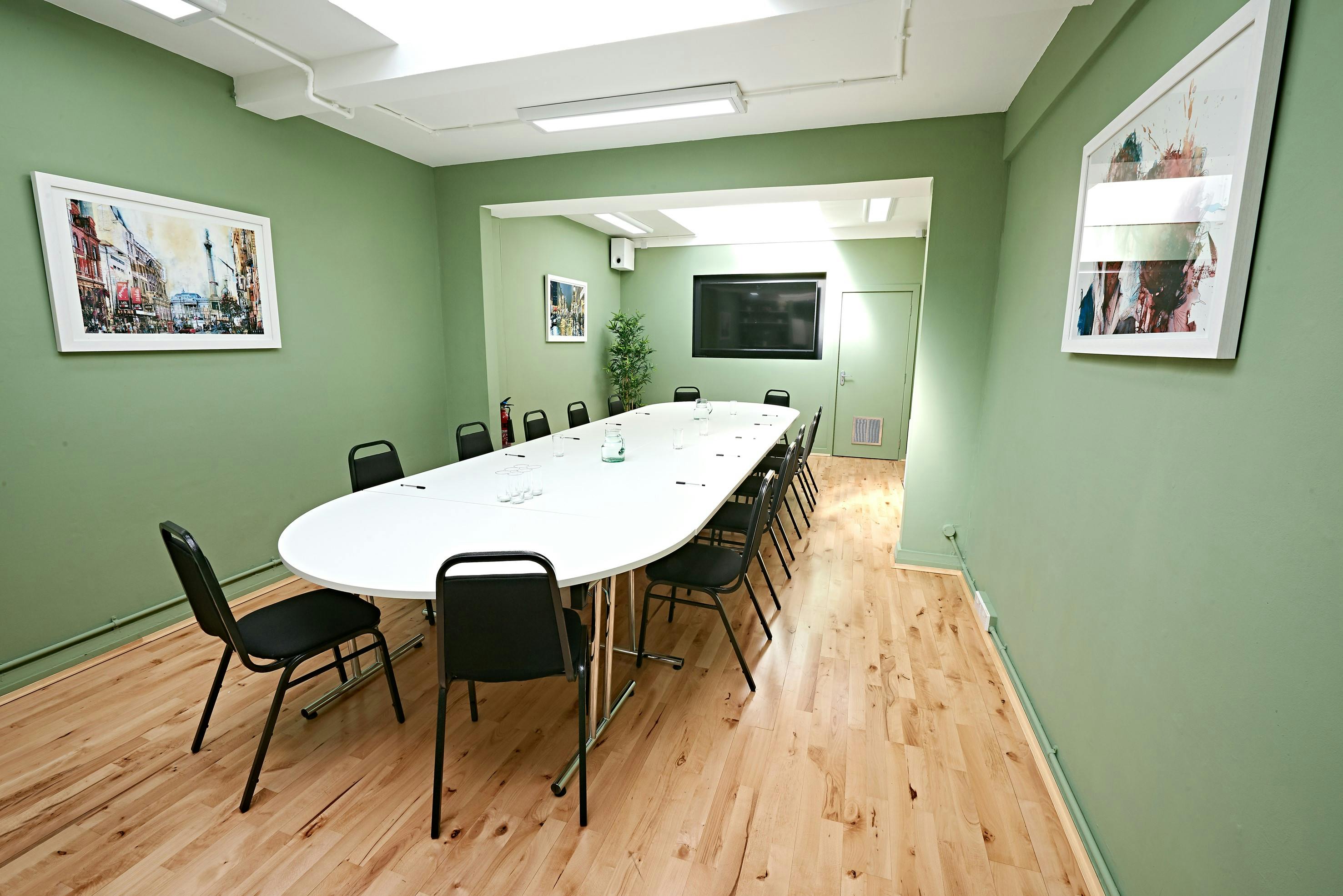 Whitehall Studio meeting room with oval table, ideal for corporate events and brainstorming.