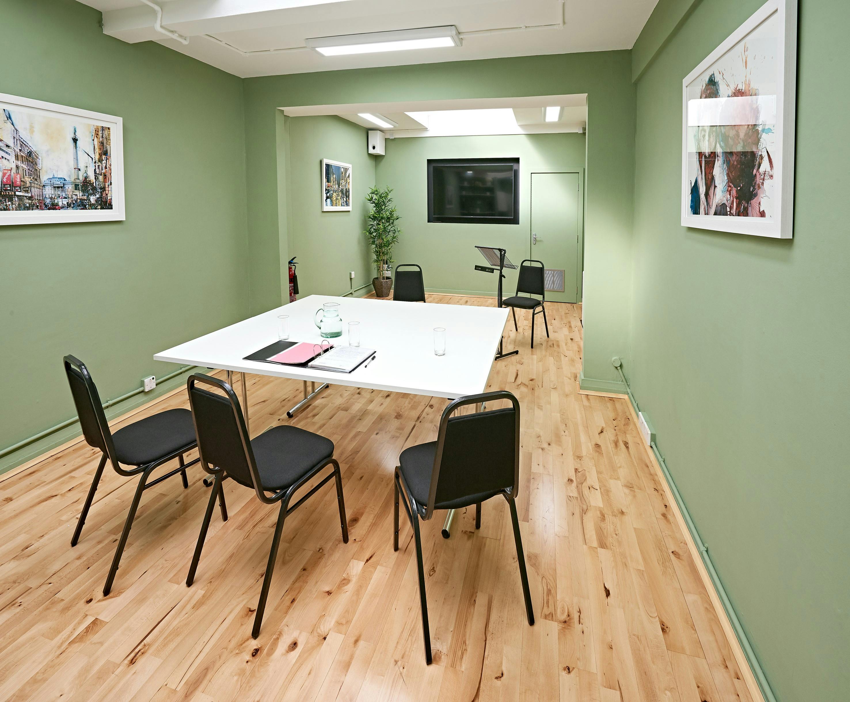 Modern meeting room at The Whitehall Studio, ideal for gatherings and presentations.