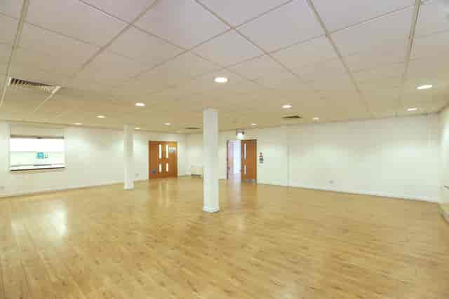 Spacious event space in St George the Martyr Church with polished wooden floors.