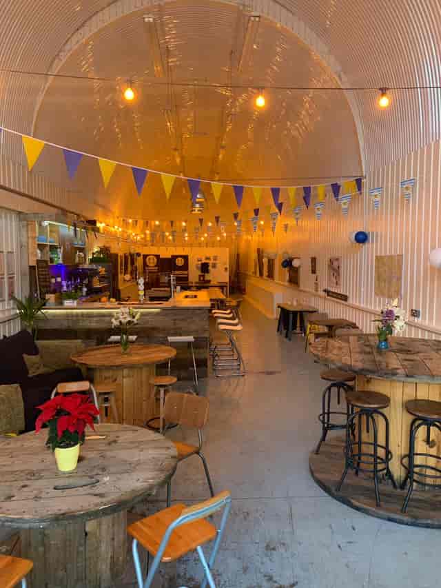 Versatile event space in London with wooden tables, ideal for networking and gatherings.