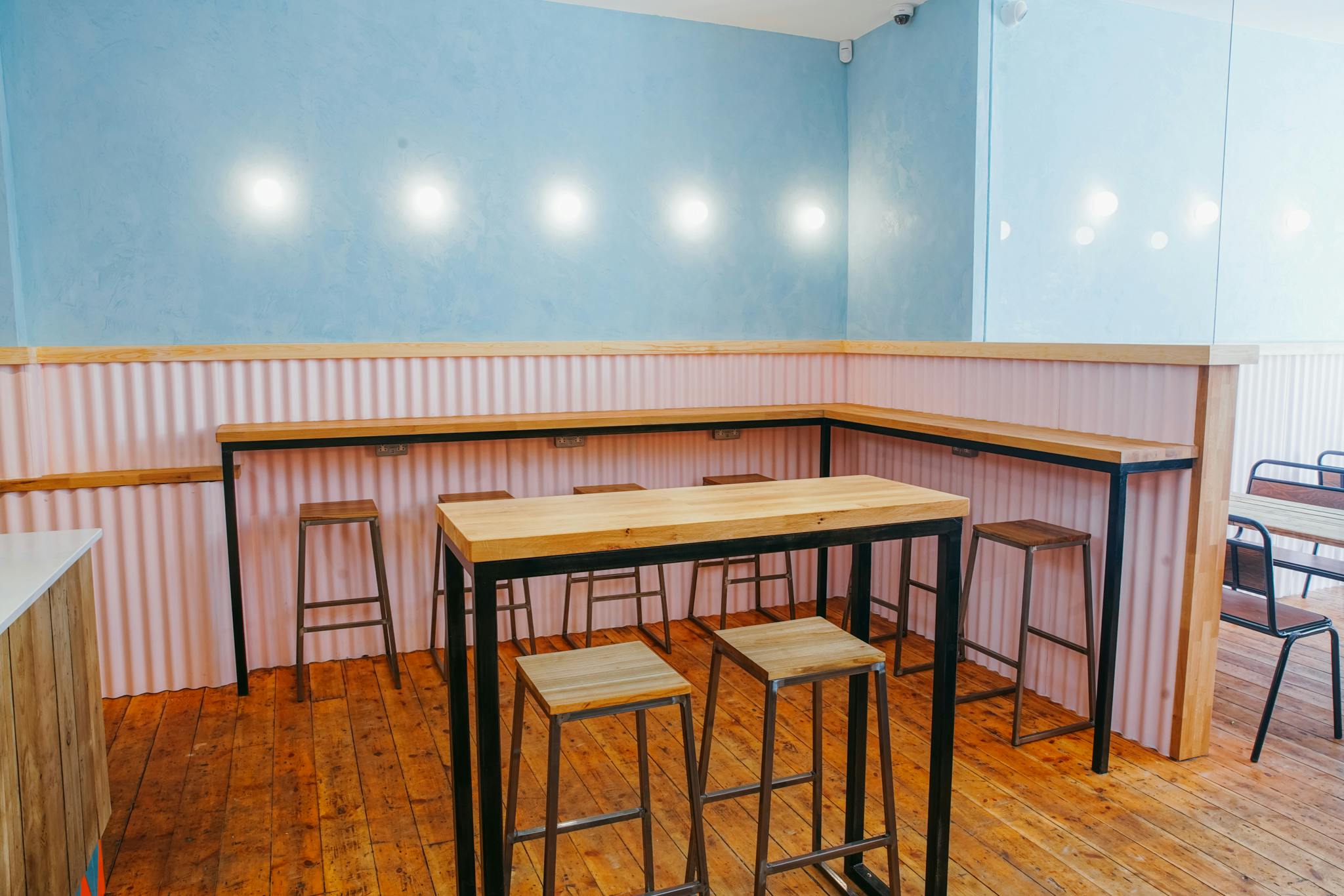 Modern event space at Fanny's Kebabs with high-top tables, ideal for networking events.