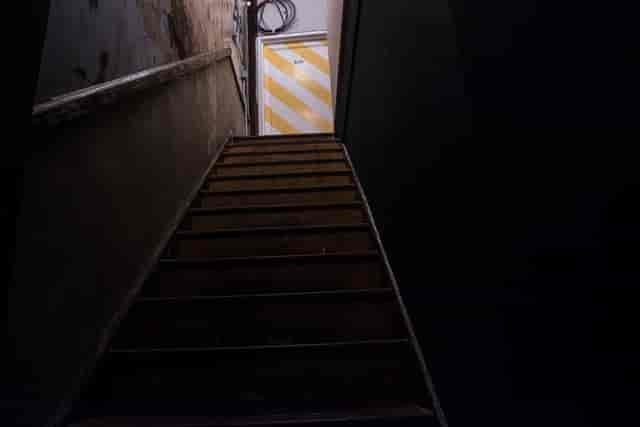 Dimly lit staircase at Fanny's Bar, ideal for unique events and safety considerations.