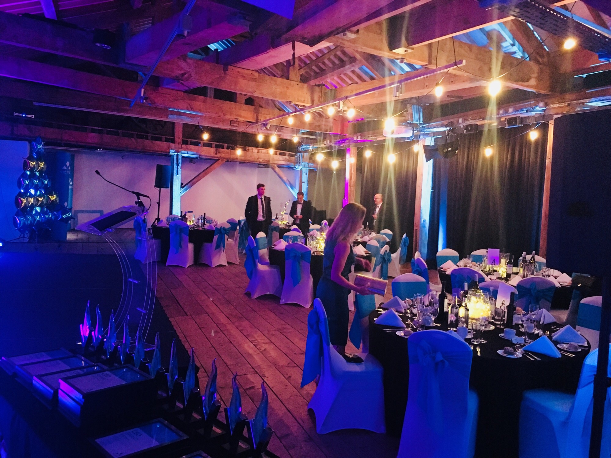 Elegant 1830 Warehouse event space with blue accents for gala or awards ceremony. - Banner