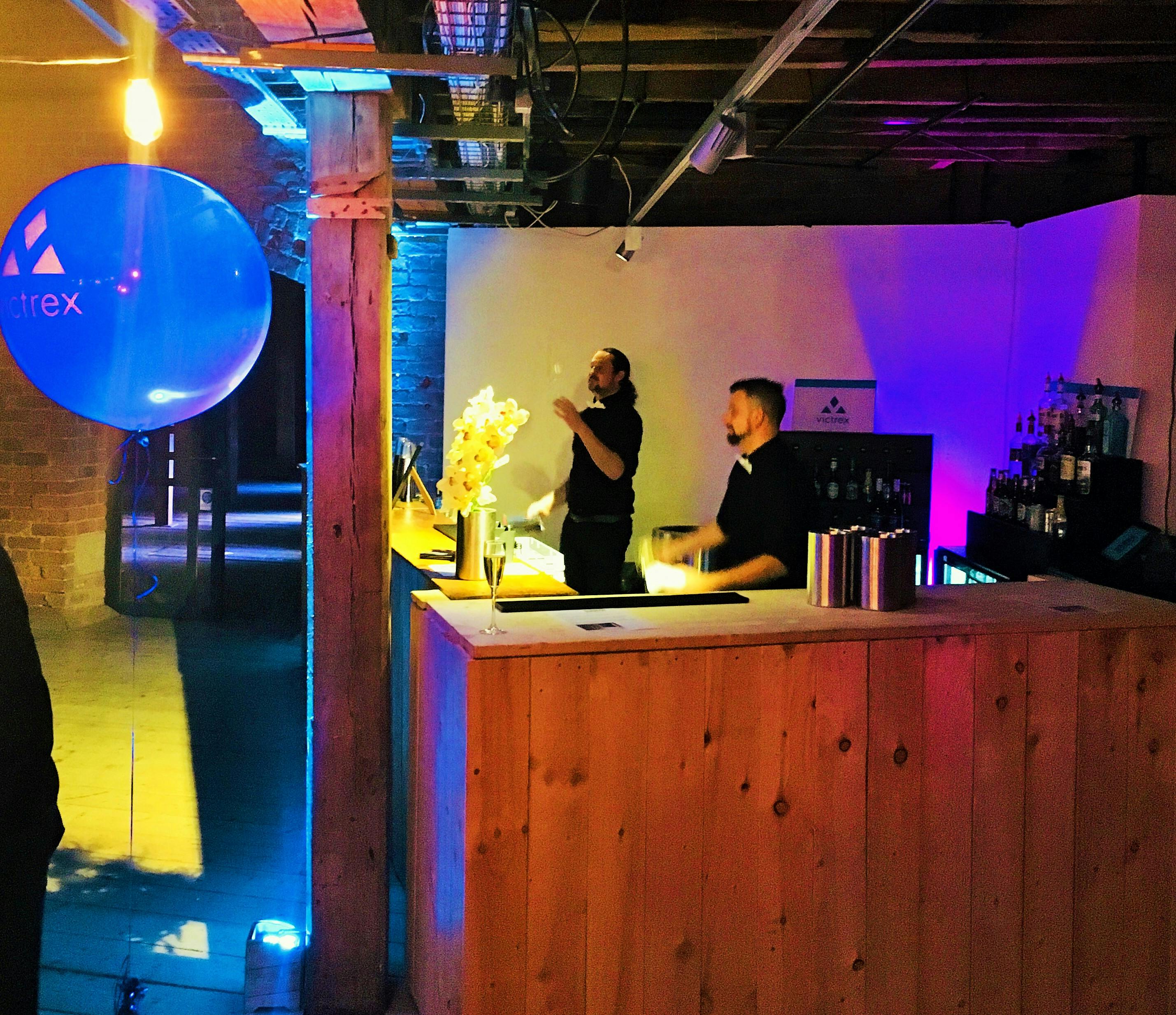 Stylish 1830 Warehouse event space with a wooden bar, perfect for networking and social gatherings.