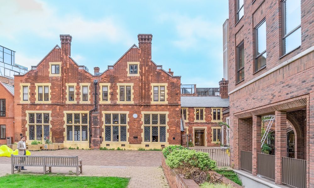 Lecture Hall at Toynbee Hall, historic venue for events with modern architecture. - Banner