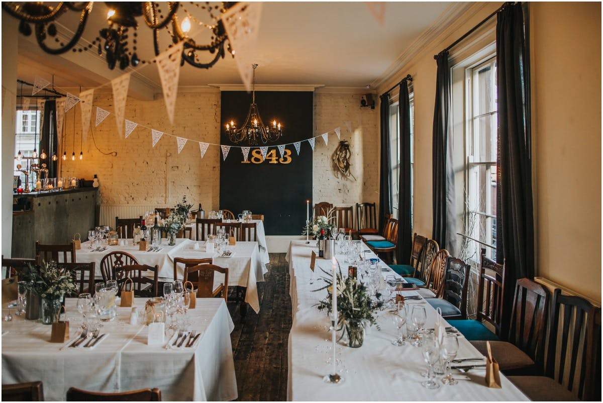 Intimate event space at The Prince Albert Camden with rustic decor, ideal for weddings.